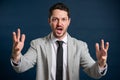 Portrait of business young male making screaming gesture