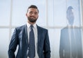 Portrait of a businessman on the background of an office window Royalty Free Stock Photo