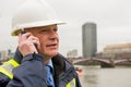 Businessman construction worker using mobile phone. Royalty Free Stock Photo