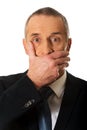 Portrait of businessman covering mouth Royalty Free Stock Photo