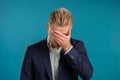 Portrait of businessman doing facepalm gesture, like no, I forgot. Unhappy guy feeling sorrow, regret, drama, failure Royalty Free Stock Photo