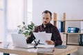 portrait of businessman doing paperwork at workplace with laptop Royalty Free Stock Photo