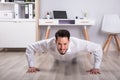 Portrait Of A Businessman Doing Push Up On Floor Royalty Free Stock Photo