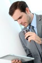 Portrait of businessman drinking take-away coffee