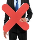 Portrait of businessman holding red cross sign