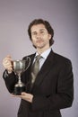 Portrait Of A Businessman Holding Trophy Royalty Free Stock Photo