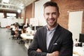 Portrait Of Businessman In Modern Open Plan Office With Business Team Working In Background Royalty Free Stock Photo