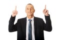 Portrait of businessman pointing upwards Royalty Free Stock Photo