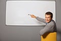 Portrait of businessman pointing at whiteboard in office Royalty Free Stock Photo