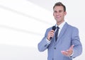 Portrait of businessman public speaking on microphone against white background Royalty Free Stock Photo