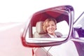 Portrait of businessman reflecting in side-view mirror of car