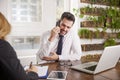 Businessman with making a call and working on laptop while sitting in the office Royalty Free Stock Photo