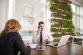 Businessman with making a call and working on laptop while sitting in the office Royalty Free Stock Photo