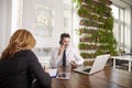 Businessman with making a call and working on laptop while sitting in the office Royalty Free Stock Photo