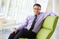 Portrait Of Businessman Sitting On Sofa In Modern Office