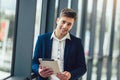 Businessman smiling while using digital tablet in office Royalty Free Stock Photo