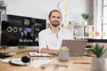 Portrait of businessman in stylish formal wear writing notes and using modern laptop Royalty Free Stock Photo