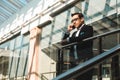 Portrait of a businessman in suit are standing on the background of glass offices. Royalty Free Stock Photo