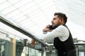 Portrait of a businessman in suit are standing on the background of glass offices. Royalty Free Stock Photo