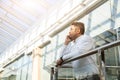 Portrait of a businessman in suit are standing on the background of glass offices. Royalty Free Stock Photo