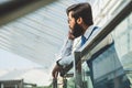 Portrait of a businessman in suit are standing on the background of glass offices. Royalty Free Stock Photo