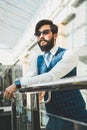 Portrait of a businessman in suit are standing on the background of glass offices. Royalty Free Stock Photo