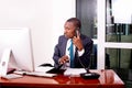 Businessman talking on mobile phone checking notes in document in office Royalty Free Stock Photo