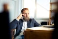 Portrait of businessman talking on mobile phone in office Royalty Free Stock Photo