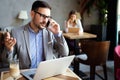 Portrait of businessman working, talking on mobile phone in office Royalty Free Stock Photo