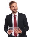 Portrait of businessman with transparent pad looking to side