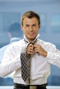 Portrait of businessman tying tie