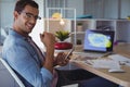 Portrait of businessman using mobile phone at creative office Royalty Free Stock Photo