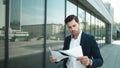 Portrait of businessman walking in slow motion. Business man throwing papers Royalty Free Stock Photo