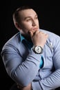 Portrait of a businessman weightlifter with large muscle in the