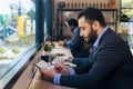 Businessman working on counter by window in coffee shop Royalty Free Stock Photo