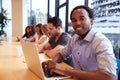 Portrait Of Businessman Working At Desk In Shared Open Plan Office Workspace Royalty Free Stock Photo