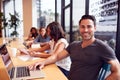 Portrait Of Businessman Working At Desk In Shared Open Plan Office Workspace Royalty Free Stock Photo