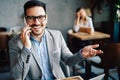 Portrait of businessman working, talking on mobile phone in office Royalty Free Stock Photo