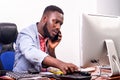 Portrait of a businessman working with telephone and computer Royalty Free Stock Photo