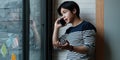 Portrait of businessmen discussing to his partners about new product while talking with mobile phone in home office. Royalty Free Stock Photo