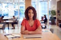 Portrait Of Businesswoman At Desk In Modern Office Work Space With Closed Laptop Royalty Free Stock Photo