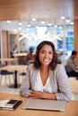 Portrait Of Businesswoman At Desk In Modern Office Work Space With Closed Laptop Royalty Free Stock Photo