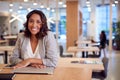 Portrait Of Businesswoman At Desk In Modern Office Work Space With Closed Laptop Royalty Free Stock Photo