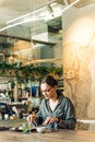 Portrait of businesswoman having lunch in a cafe. Young female entrepreneur eating salad at lunch Royalty Free Stock Photo