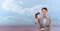 Portrait of businesswoman holding binoculars while standing against sky Royalty Free Stock Photo
