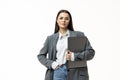 Portrait of a businesswoman holding laptop computer iand looking away solated over white background Royalty Free Stock Photo