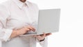 Portrait businesswoman holding silver laptop in the office isolated