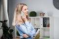 Portrait of businesswoman with mobile phone standing at office. young Caucasian businesswoman holding mobile phone in office. Royalty Free Stock Photo