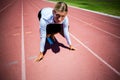 Portrait of businesswoman ready to run on running track Royalty Free Stock Photo