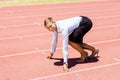 Portrait of businesswoman ready to run on running track Royalty Free Stock Photo